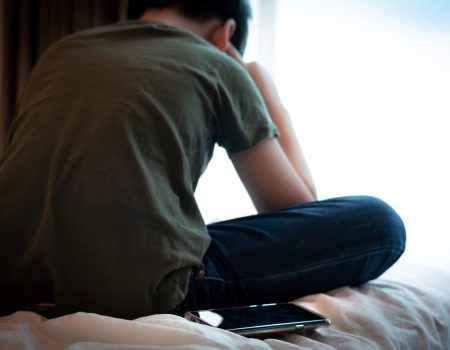 Cyber bullying concept. Back oa a young asian tween / teenage bo